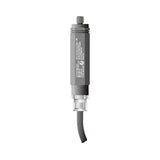 Gray cylindrical device with a wire on a white background.