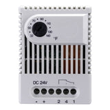 White electronic thermostat with temperature control knob and wiring ports on a white background.