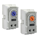 Two wall-mounted DIN rail enclosure thermostats with adjustable dials, one labeled for heating in Fahrenheit with a blue dial, and the other for cooling in Celsius with an orange dial.